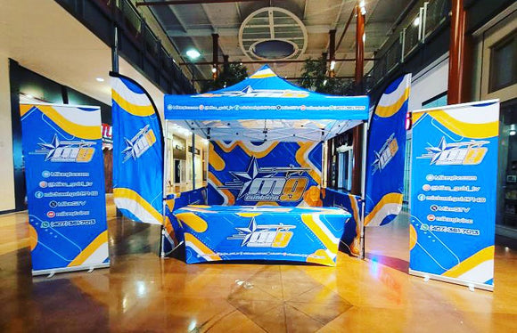 10' x 10' Pop-Up Tent with Double-Sided Full Wall and Half Walls, (2) Double-Sided 8’ Flags with Tent Attachments, (2) Roll-Up Banners, 6’ Table Cover