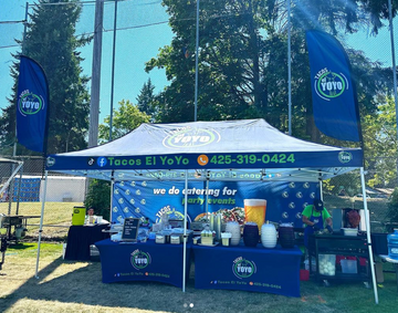 10' x 20' Pop-Up Tent with Single-Sided Full Wall, (2) 6' Stretch-Fit Table Covers, and (2) 8' Double-Sided Flags with Tent Attachments